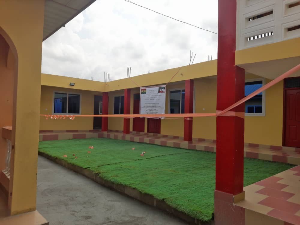 School courtyard with covered walkways and colourful pillars